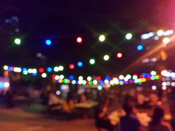 Defocused image of illuminated city at night