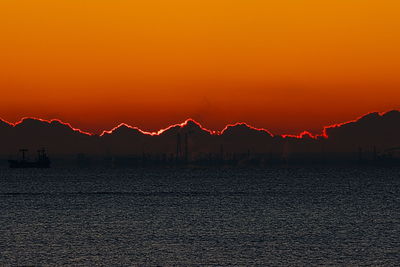 Scenic view of sea against romantic sky at sunset