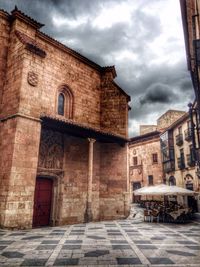 Buildings against cloudy sky