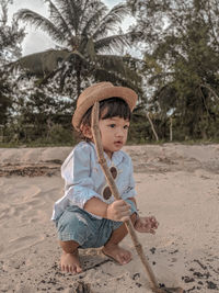 Full length of cute baby girl on sand at beach