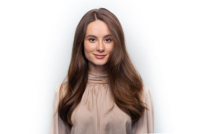 Portrait of a smiling young woman over white background