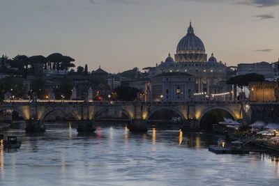 St peters basilica over tiber river during sunset in city