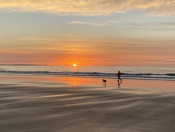 Scenic view of beach against sky during sunset