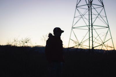 Silhouette man standing on field against clear sky