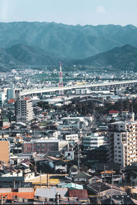 High angle view of city and mountains against sky