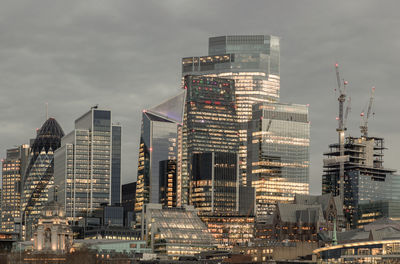 Modern buildings in city against sky