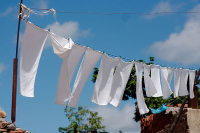 Laundry drying on an outside line. all white pillow cases.