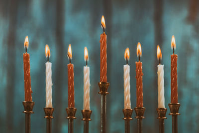 Close-up of burning candles in temple