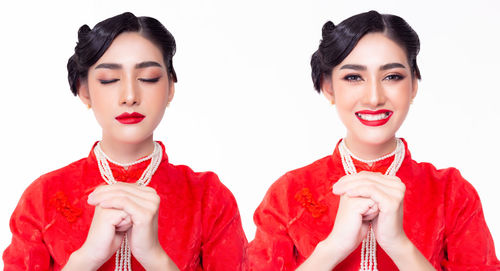 Portrait of a smiling young woman against white background