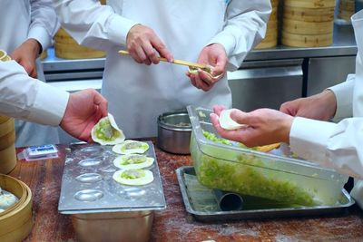 Midsection of man preparing food in kitchen