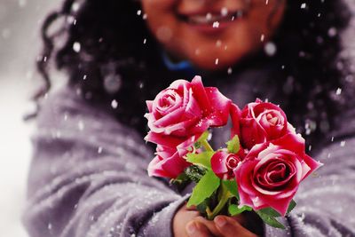 Close-up of hand holding rose bouquet