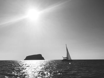 Sailboat on sea against sky