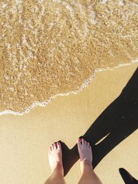 Low section of woman standing on beach