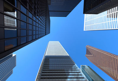 Low angle view of modern buildings against clear blue sky