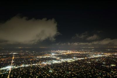 High angle view of city lit up at night