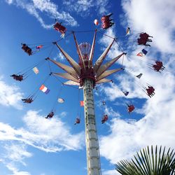 Low angle view of chain swing ride against sky