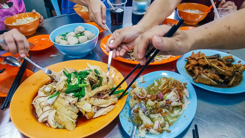 Midsection of man eating food in restaurant