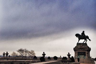 Low angle view of monument against cloudy sky