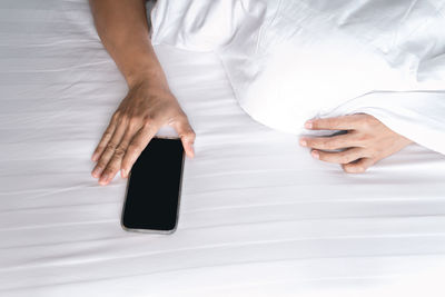 High angle view of man hand on white table