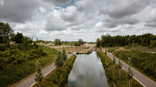 Panoramic view of canal amidst buildings against sky