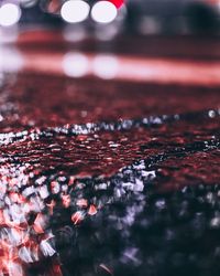 Close-up of illuminated lights reflecting in puddle