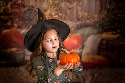 Portrait of young woman with pumpkin