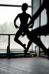 Silhouette ballet dancer practicing at ballet studio