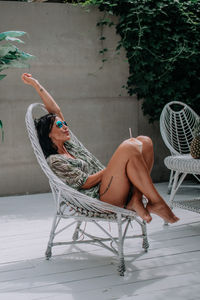 Midsection of woman sitting on chair