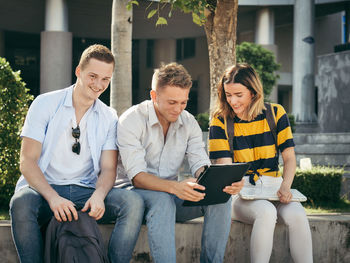 Young couple sitting on smart phone