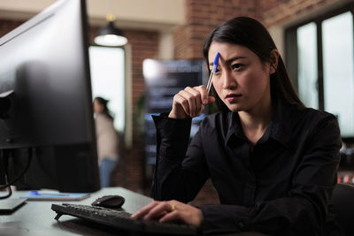 Thoughtful businesswoman working at office