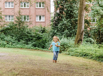 Full length of girl running in yard