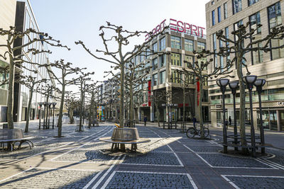 View of city street and buildings against sky