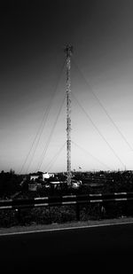 Electricity pylon on field against sky