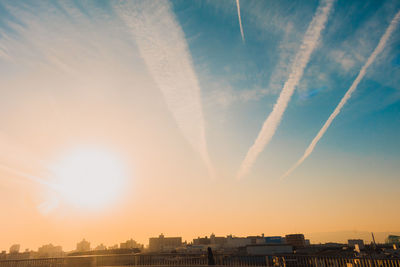 Low angle view of cityscape against sky during sunset