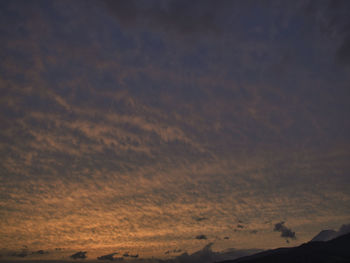 Low angle view of silhouette mountain against dramatic sky