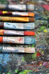 Close-up of paintbrushes on dirty table