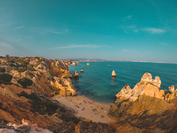 Panoramic view of rocks on sea shore against sky