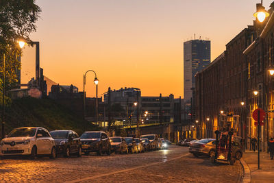 Cars on road at sunset