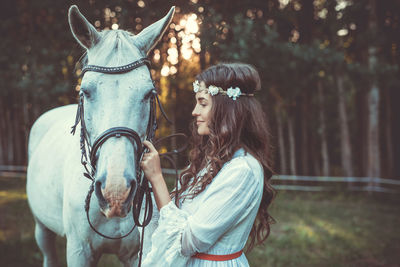 Side view of woman with horse