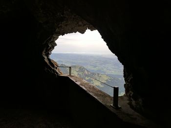 Scenic view of mountain seen through cave