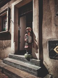 Man standing by old building