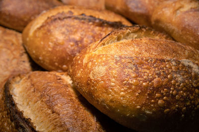 Appetizing fresh hot artisan bread. close-up of a loaf of delicious bread on a wooden pallet