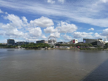 Buildings in city against cloudy sky