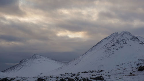 Scenic view of snow covered mountains against sky during sunset