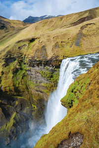 High angle view of beautiful skogafoss waterfall falling from mountain