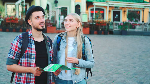 Young couple standing in city