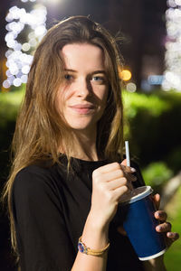 Portrait of a beautiful young woman drinking water