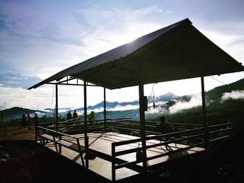 Built structure by swimming pool against sky