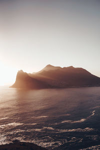Scenic view of sea against clear sky during sunset