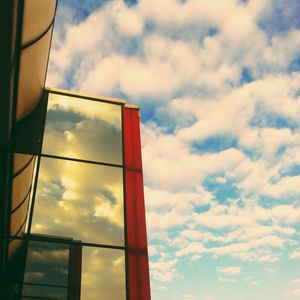 Low angle view of building against cloudy sky